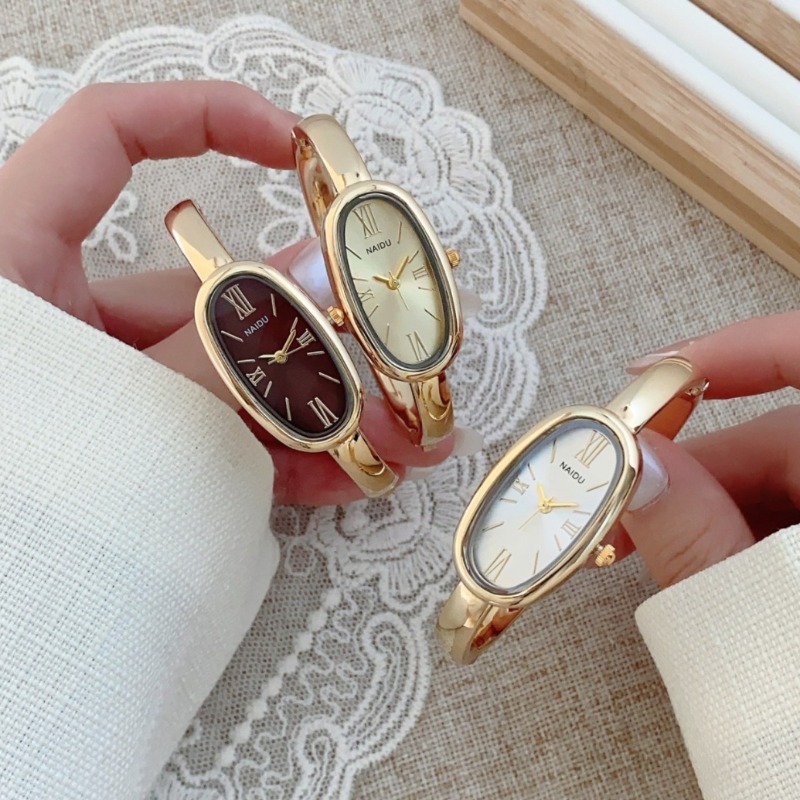 Luxury Watch Index - นาฬิกาข้อมือควอตซ์ทรงรี หน้าปัดโรมัน แบรนด์ดังสำหรับผู้หญิง ดีไซน์เรียบหรู สีทอง พร้อมสายแบบกำไลข้อมือ